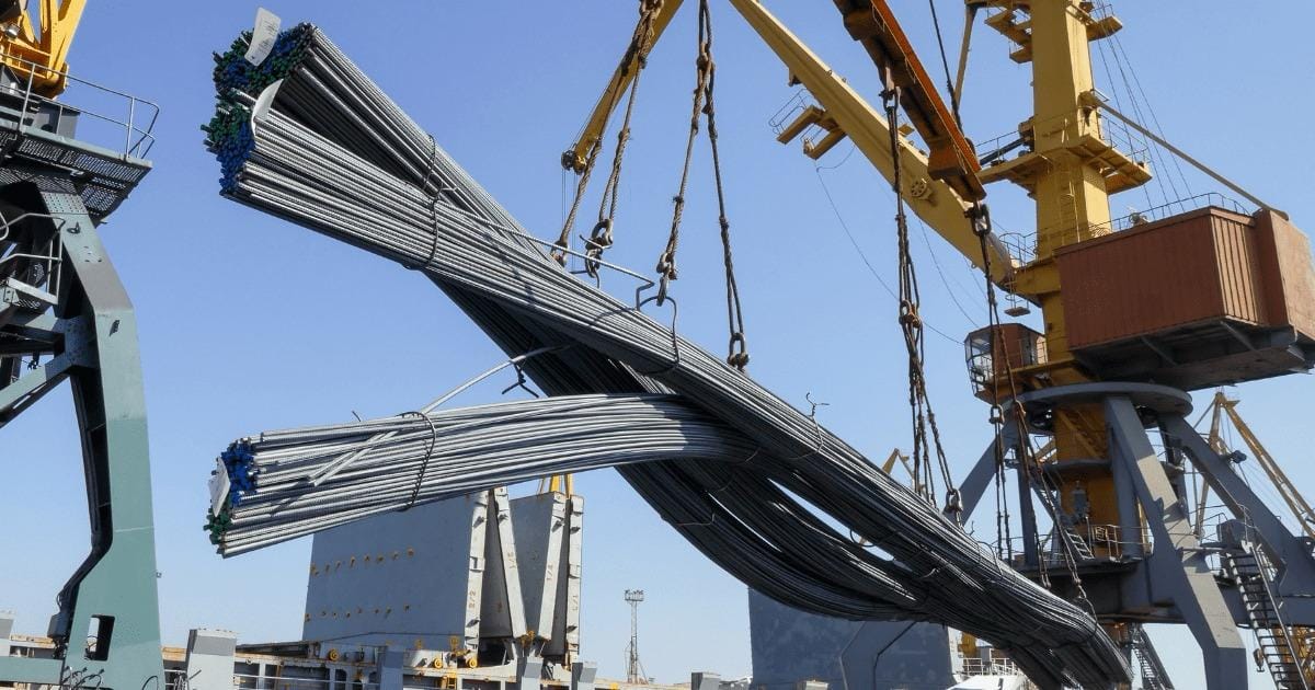 Crane lifting bundles of steel rebar at a port. Steel rebar import/export. -Shipping Company in Egypt